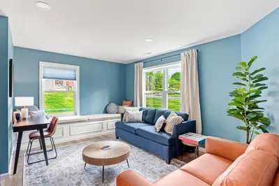 a living room with blue walls and a blue couch at The Respite getaway in Harrisburg