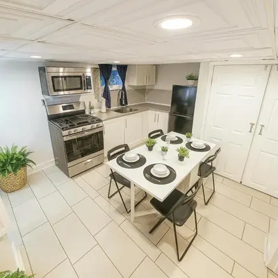 a kitchen with a table and chairs in a kitchen at Nice 3BR Apt | 3 Beds |15 Min to NYC/Manhattan! in North Bergen