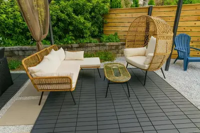 a patio with two chairs and a couch and a table at Nice 3BR Apt | 3 Beds |15 Min to NYC/Manhattan! in North Bergen