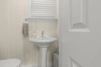 a white bathroom with a sink and a toilet at Chestnut Hill 2BR Easy Parking in Philadelphia
