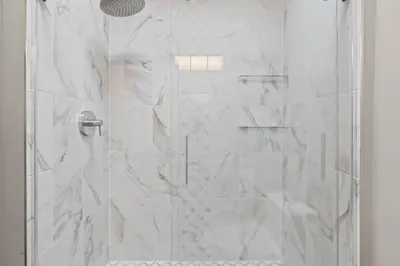 a bathroom with a shower with a glass door at Chestnut Hill 2BR Easy Parking in Philadelphia