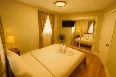 a bedroom with a bed with a bow on it at 2 BR Apt|15 Min to NYC|Book Today in North Bergen