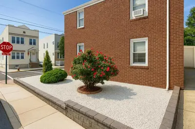 a stop sign in front of a brick building at 2 BR Apt|15 Min to NYC|Book Today in North Bergen