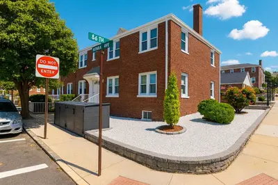 a stop sign in front of a brick building at 2 BR Apt|15 Min to NYC|Book Today in North Bergen