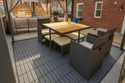 a wooden table and chairs on a patio at 2 BR Apt|15 Min to NYC|Book Today in North Bergen