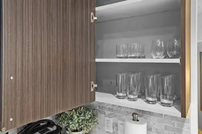a kitchen with glasses on shelves in a kitchen at Luxury 1BR Apt-Pool RWJ-Rutgers StPeter-Free Parking - NYC316 in New Brunswick