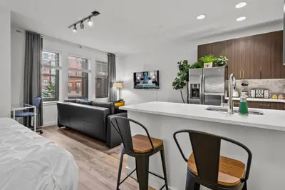 a kitchen and living room with a bed and a couch at Luxury 1BR Apt-Pool RWJ-Rutgers StPeter-Free Parking - NYC316 in New Brunswick