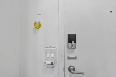 a white refrigerator with a ticket dispenser on it at Luxury 1BR Apt-Pool RWJ-Rutgers StPeter-Free Parking - NYC316 in New Brunswick