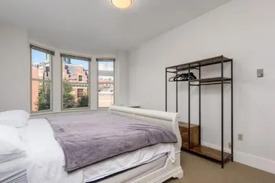 a white bedroom with a bed and a window at Capitol View Retreat - 2F Fast Wi-Fi Spacious in Harrisburg