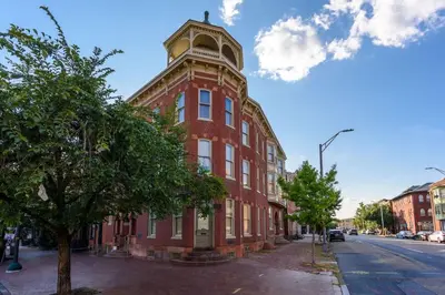 a red brick building with a clock tower on a street at Capitol View Retreat - 2F Fast Wi-Fi Spacious in Harrisburg