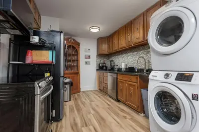 a kitchen with a refrigerator and a washer and dryer at Capitol View Retreat - 2F Fast Wi-Fi Spacious in Harrisburg