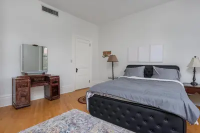 a bedroom with a large bed and a mirror at Capitol View Retreat - 2F Fast Wi-Fi Spacious in Harrisburg