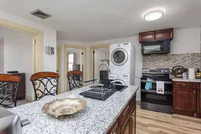 a kitchen with a counter top with a stove top oven at Capitol View Retreat - 3F Fast Wi-Fi Cozy in Harrisburg