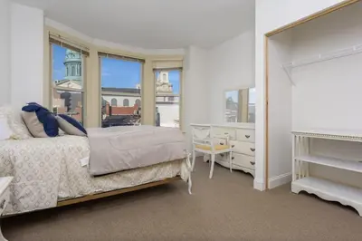 a bedroom with a bed and a large window at Capitol View Retreat - 3F Fast Wi-Fi Cozy in Harrisburg