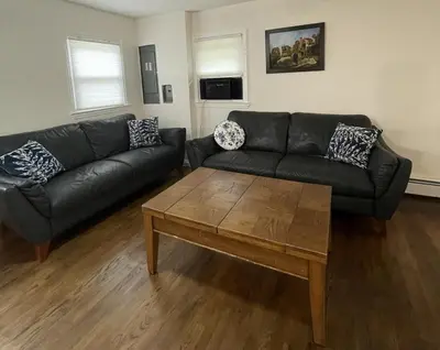 a living room with a couch and a coffee table at Cozy Winter Chalet on 5 Acres - Fire Pit & Views in Livingston Manor