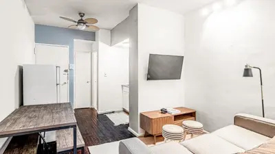 a living room with a couch and a table at 2 Bedroom Apartment in Midtown Manhattan - Near NYC Icons! in New York