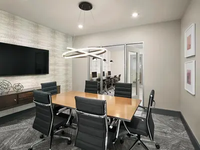 a conference room with a wooden table and black chairs at AVE Union - Furnished Apartment, Union NJ in Union