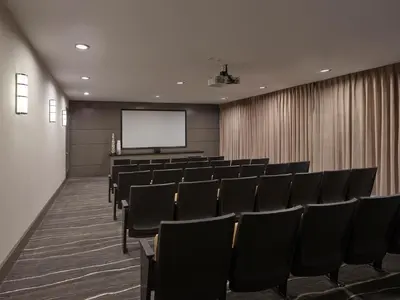 a conference room with chairs and a screen at AVE Union - Furnished Apartment, Union NJ in Union