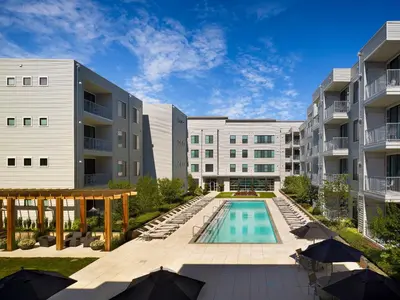 an exterior view of a building with a swimming pool at AVE Union - Furnished Apartment, Union NJ in Union