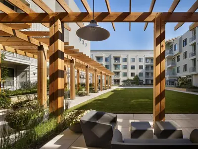a patio with chairs under a wooden pergola at AVE Union - Furnished Apartment, Union NJ in Union