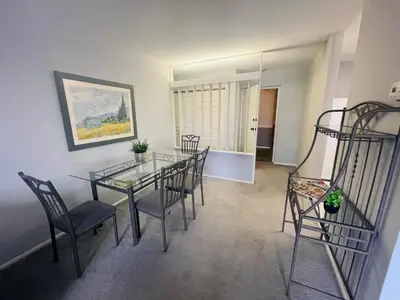a dining room with a glass table and chairs at Pet-Friendly 1BR Condo Free Parking, Discount! in Elkins Park