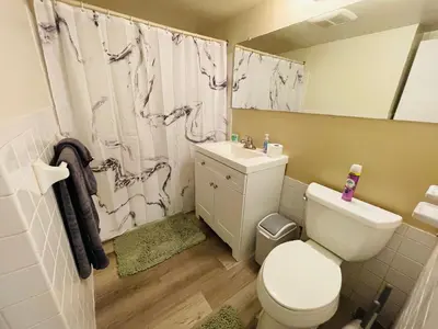 a bathroom with a toilet and a sink and a shower at Pet-Friendly 1BR Condo Free Parking, Discount! in Elkins Park