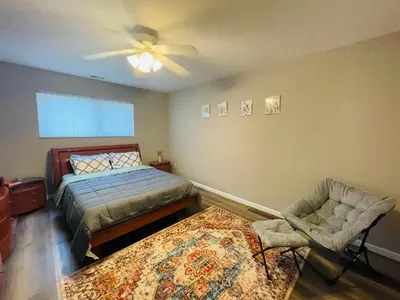 a bedroom with a bed and a fan and a chair at Pet-Friendly 1BR Condo Free Parking, Discount! in Elkins Park