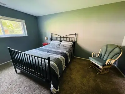 a bedroom with a bed and a chair at Spacious 2BR2BA Monthly Discount in Elkins Park