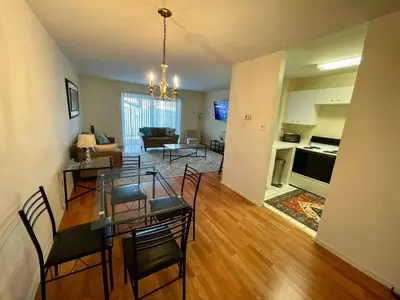 a living room with a dining table and a kitchen at Bright & Spacious 2BR2BA Monthly Savings in Philadelphia