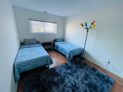 a room with two beds and two rugs at Bright & Spacious 2BR2BA Monthly Savings in Philadelphia
