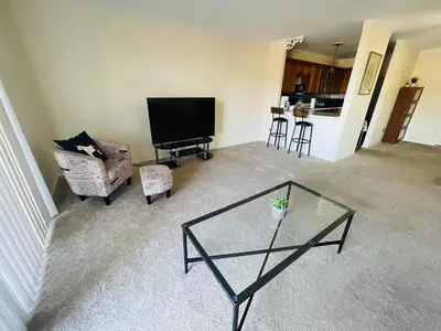 a living room with a glass table and a television at Renovated 2BR 2BA Monthly Savings in Philadelphia