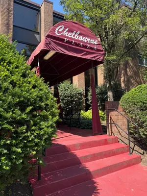 a red umbrella on the steps of a building at Renovated 2BR 2BA Monthly Savings in Philadelphia
