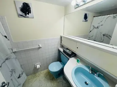 a bathroom with a blue toilet and a sink at Renovated 2BR 2BA Monthly Savings in Philadelphia