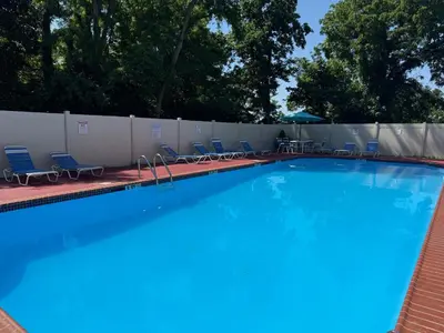a large swimming pool with chairs and a fence at Renovated 2BR 2BA Monthly Savings in Philadelphia