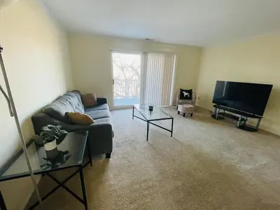 a living room with a couch and a flat screen tv at Renovated 2BR 2BA Monthly Savings in Philadelphia