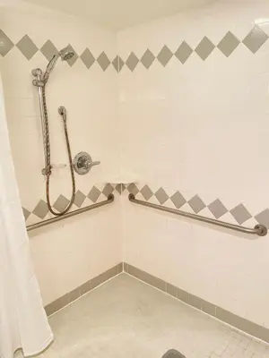 a shower in a tiled bathroom with at Wheelchair accessible & ground floor 2BR, 2BA in Elkins Park