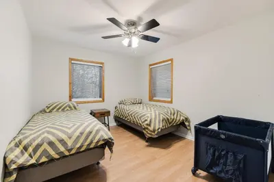 a bedroom with two beds and a ceiling fan at Mansion in the Hills with Pool in Monroe