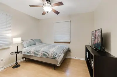 a bedroom with a bed and a ceiling fan at Mansion in the Hills with Pool in Monroe