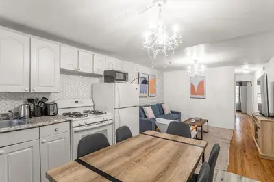 a kitchen and dining room with a table and a dining room at Spacious 3BR Apartment in Kips Bay - Central Manhattan Location! in New York