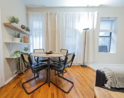 a dining room with a table and four chairs at Spacious 3BR Near Columbia Uni & Riverside Park in New York