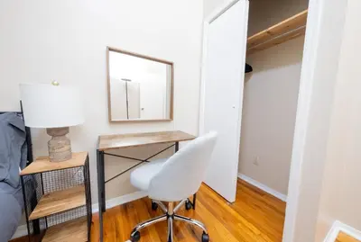 a bedroom with a desk and a chair and a mirror at Spacious 3BR Near Columbia Uni & Riverside Park in New York
