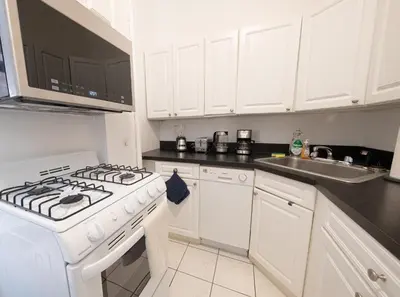 a white kitchen with a stove and a sink at Spacious 3BR Near Columbia Uni & Riverside Park in New York