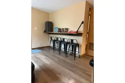 a kitchen with a bar with stools in a room at Sweet Darlene with Hot Tub, Game Room and Pet Friendly in Albrightsville