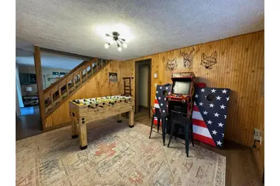 a room with a table and a video game at Sweet Darlene with Hot Tub, Game Room and Pet Friendly in Albrightsville