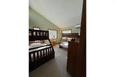 a room with two bunk beds and a room with a bedsenalsenal at Sweet Darlene with Hot Tub, Game Room and Pet Friendly in Albrightsville