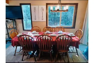 a dining room table with chairs and a red table cloth at Sweet Darlene with Hot Tub, Game Room and Pet Friendly in Albrightsville