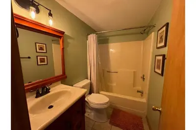 a bathroom with a sink and a toilet and a shower at Sweet Darlene with Hot Tub, Game Room and Pet Friendly in Albrightsville