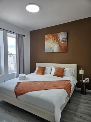 a bedroom with a large bed and a large window at 20 minutes to Central Park Manhattan New York City 16 mins Metlife stadium in West New York