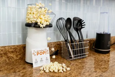 a food processor on a counter with popcorn and utensils at Fast transit to Manhattan with Parking on premises in North Bergen