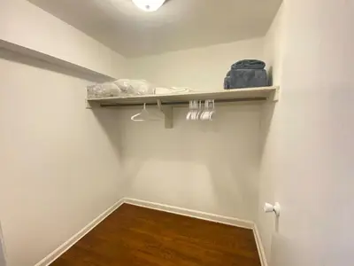 a room with white walls and a wooden floor at Fast transit to Manhattan with Parking on premises in North Bergen